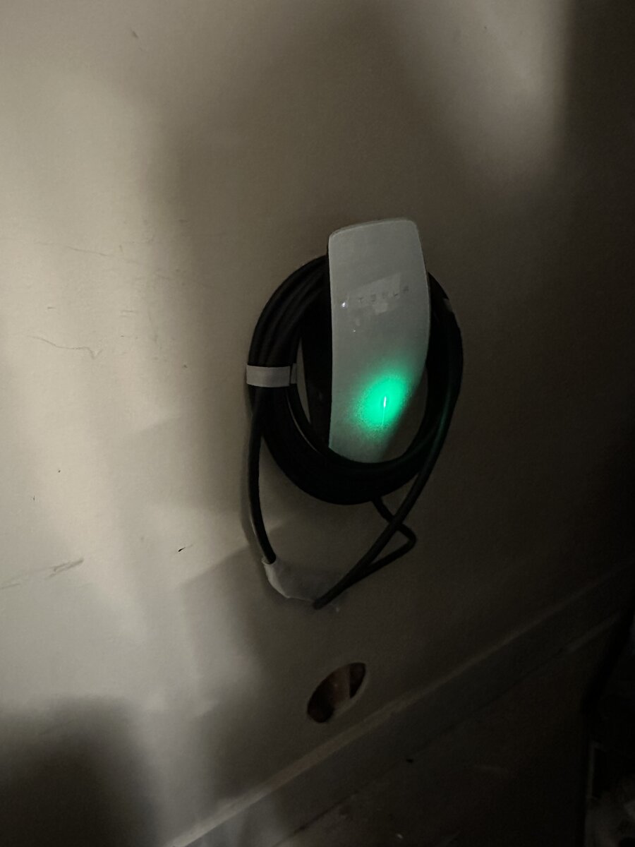 Tesla Wall Connector mounted on residential garage wall